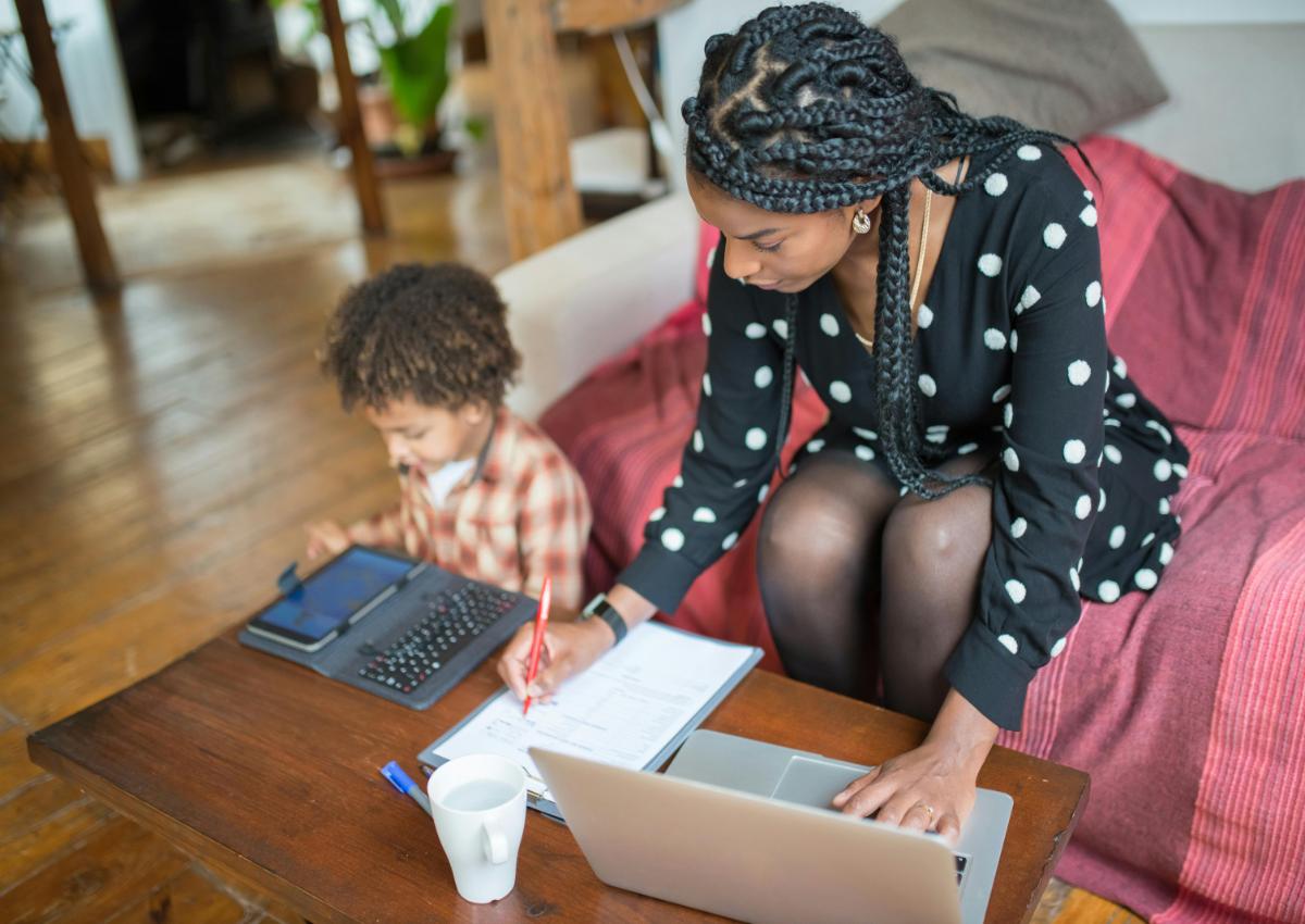woman working at home with child on a tablet